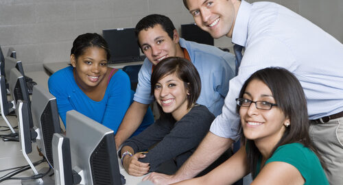 professor with students working in computer lab