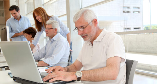 Senior man working on laptop computer