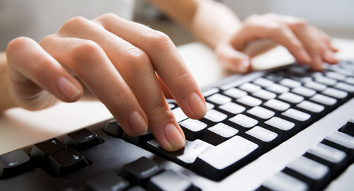 female hands touching keyboard